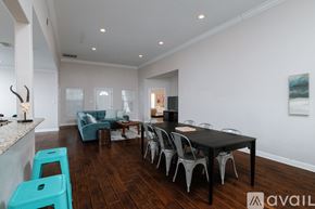 Dallas house for rent - A modern dining room with a black table and chairs.