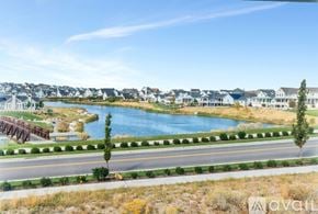 South Jordan townhouse for rent - A bridge over a blue lake with houses in the background.