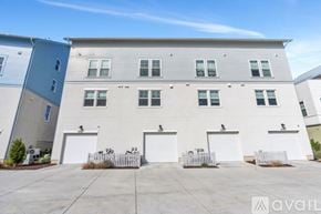 South Jordan townhouse for rent - A row of white garage doors in front of a building.