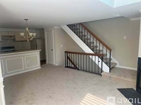 Alexandria condo for rent - A living room with a staircase leading to the upper floor.