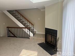 Alexandria condo for rent - A living room with a fireplace and a staircase.