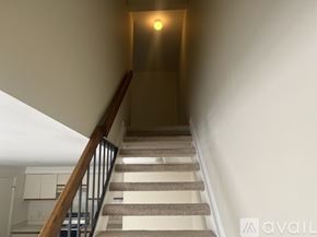 Alexandria condo for rent - A staircase with a light on the wall at the top.