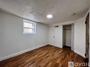 Revere apartment for rent - A room with wooden floors and a window.