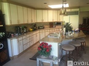 Rancho Mirage condo for rent - A kitchen with white cabinets and a wooden island.