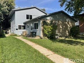 Madison apartment for rent - A house with a grey siding and a brown roof with a small front yard.
