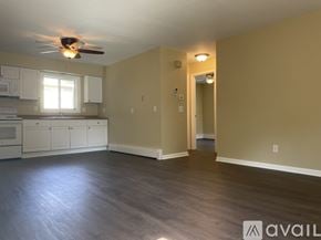 Madison apartment for rent - A spacious room with a ceiling fan and lighting fixture.
