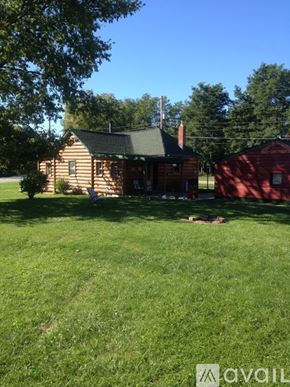 Indianapolis house for rent - A house with a red shed in the backyard.