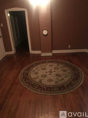 Indianapolis house for rent - A room with a rug on the floor and a doorway leading to another room.