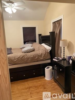Collegeville house for rent - A bedroom with a bed, nightstand, and a ceiling fan.