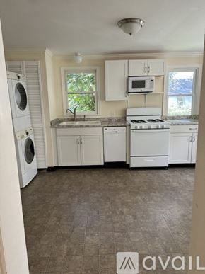 Collegeville house for rent - A kitchen with white appliances and cabinets.
