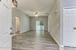 Jacksonville condo for rent - A spacious room with wooden flooring and white walls.