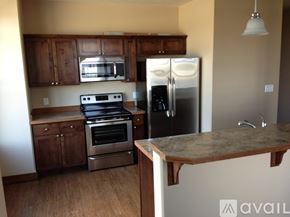 Helena apartment for rent - A kitchen with a refrigerator, oven, and microwave.