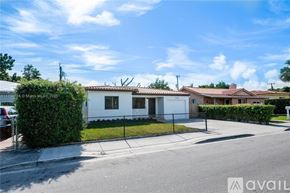 Miami house for rent - A row of houses with a clear blue sky above them.
