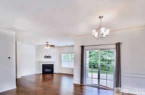 Greer house for rent - A spacious living room with a fireplace and sliding glass doors.