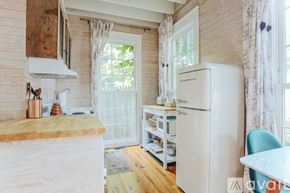 Charlottesville townhouse for rent - A kitchen with a white refrigerator and wooden cabinets.