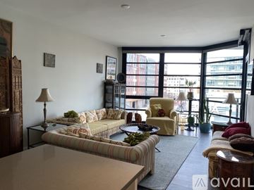 Washington condo for rent - A living room with a striped couch and a coffee table.