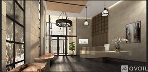 Washington condo for rent - A modern interior space with a long hallway, a reception desk, and hanging light fixtures.