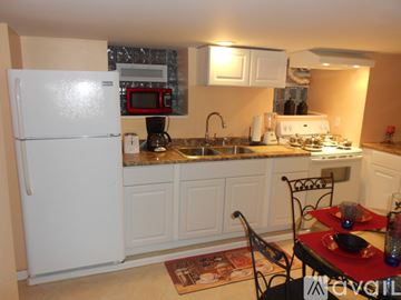 Niagara Falls apartment for rent - A kitchen with a white refrigerator and a sink.