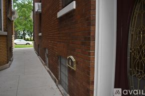 Niagara Falls apartment for rent - A red brick building with a white door and a window.