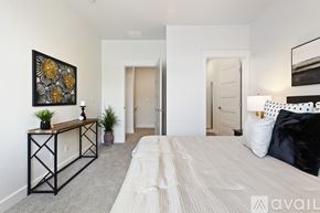 Boise townhouse for rent - A bedroom with a large bed and a painting on the wall.