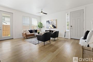 Boise townhouse for rent - A living room with a black chair and a white chair.