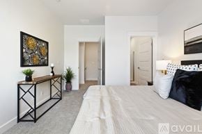 Boise townhouse for rent - A bedroom with a large bed and a painting on the wall.