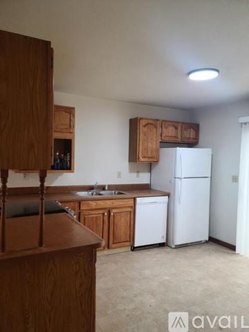 Billings townhouse for rent - A kitchen with wooden cabinets and a white refrigerator.