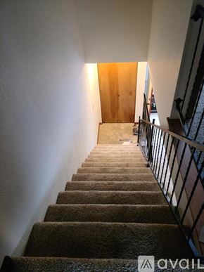 Billings townhouse for rent - A staircase with a carpeted runner and a metal railing.