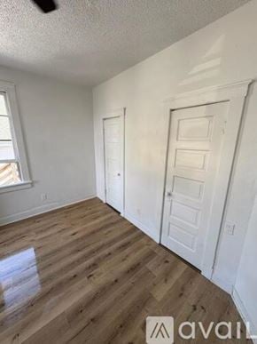 Marshalltown apartment for rent - A room with wooden flooring and two white doors.