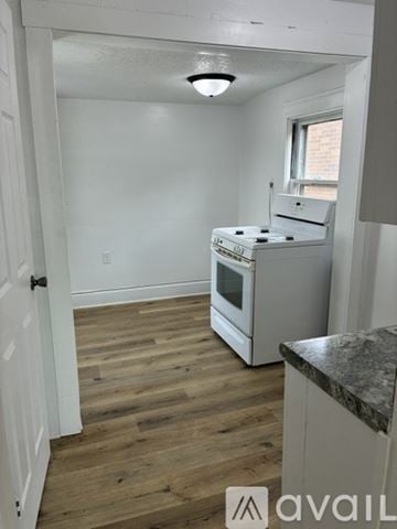 Marshalltown apartment for rent - A kitchen with a white stove and wooden floors.