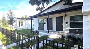 St Petersburg townhouse for rent - A white house with a black fence in front of it.