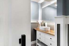 Parker house for rent - A bathroom with a sink and mirror.