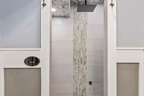 Parker house for rent - A modern bathroom with a glass shower enclosure.