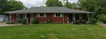 Belleville house for rent - A red brick house with a grey roof and a white door.