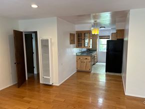 West Hollywood apartment for rent - A kitchen with wooden floors and white walls.