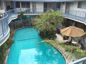 West Hollywood apartment for rent - A small pool surrounded by a balcony and trees.
