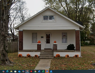 Cape Girardeau house for rent - A small white house with a red brick chimney and a front porch.