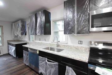 West Springfield house for rent - A kitchen with black cabinets and appliances is under construction.