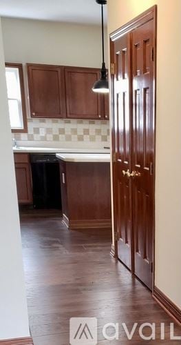 Lewis Center house for rent - A kitchen with wooden cabinets and a checkered backsplash.
