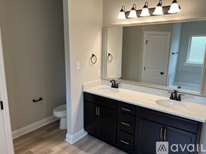 Youngsville house for rent - A bathroom with a white countertop and black cabinets.