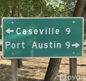 Port Austin house for rent - A green sign with white text indicating directions to Caseville and Port Austin.