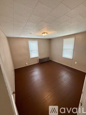 Morgantown apartment for rent - A living room with a sofa, chairs, and pictures on the wall.