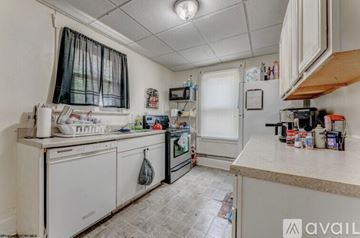 Morgantown apartment for rent - A kitchen with white appliances and a tiled floor.