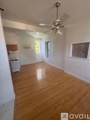 Albany apartment for rent - A room with wooden flooring and a ceiling fan.