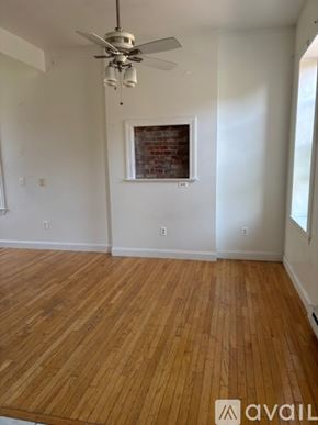 Albany apartment for rent - A room with wooden flooring and a ceiling fan.