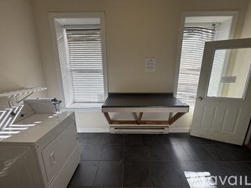 Albany apartment for rent - A kitchen with a white sink and black tiles on the floor.