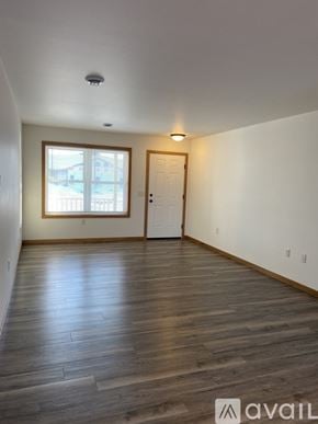 Tomah apartment for rent - A room with wooden flooring and a window.