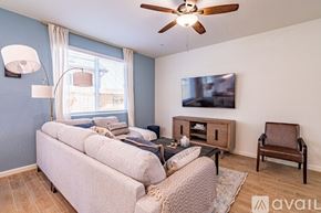 Fresno house for rent - A living room with a couch, chair, and television.