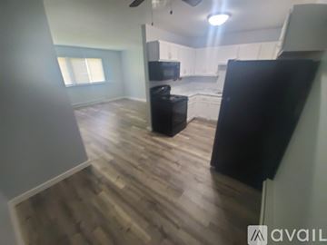 La Crosse apartment for rent - A kitchen with a black refrigerator and wooden floors.