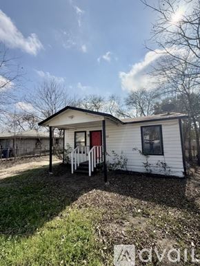 San Antonio house for rent - A small white house with a red door and a porch.